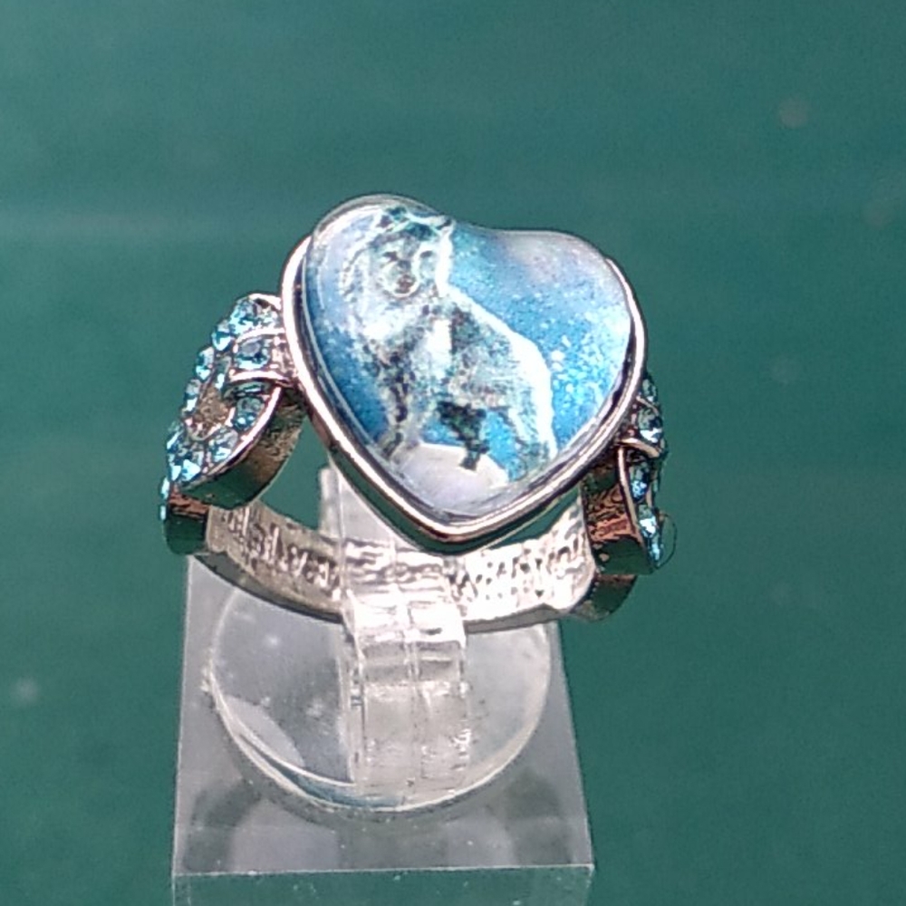 Wolf heart ring with light blue cubic stones.